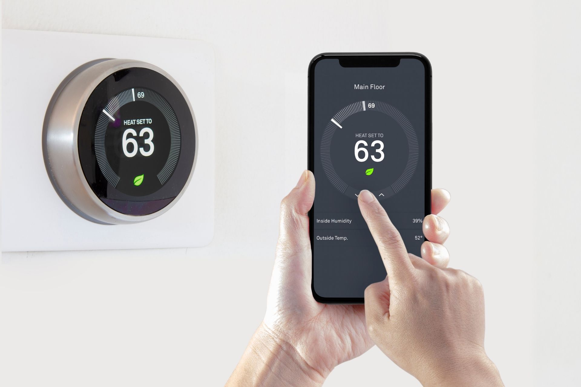 woman controls smart thermostat from app on her phone.
