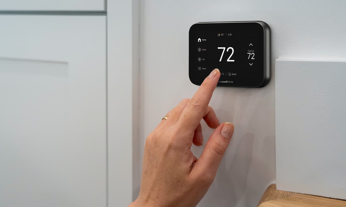 Customer setting temperature on a Smart thermostat.
