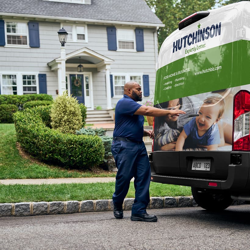 A Hutchinson technician arrives at a home ready to provide expert HVAC, plumbing, and electrical services.