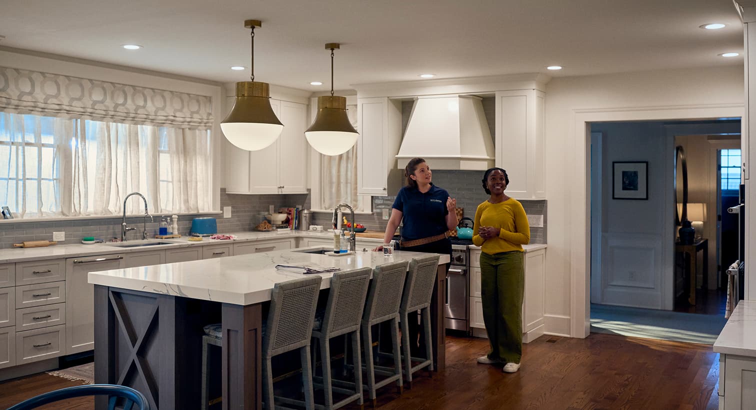 A Hutchinson electrician consulting with a homeowner about modern residential lighting design and complete home electrical services