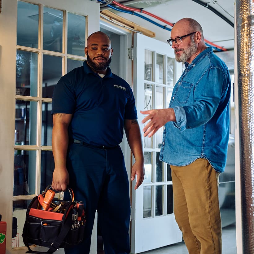A Hutchinson technician discusses the repair and installation services with a homeowner.