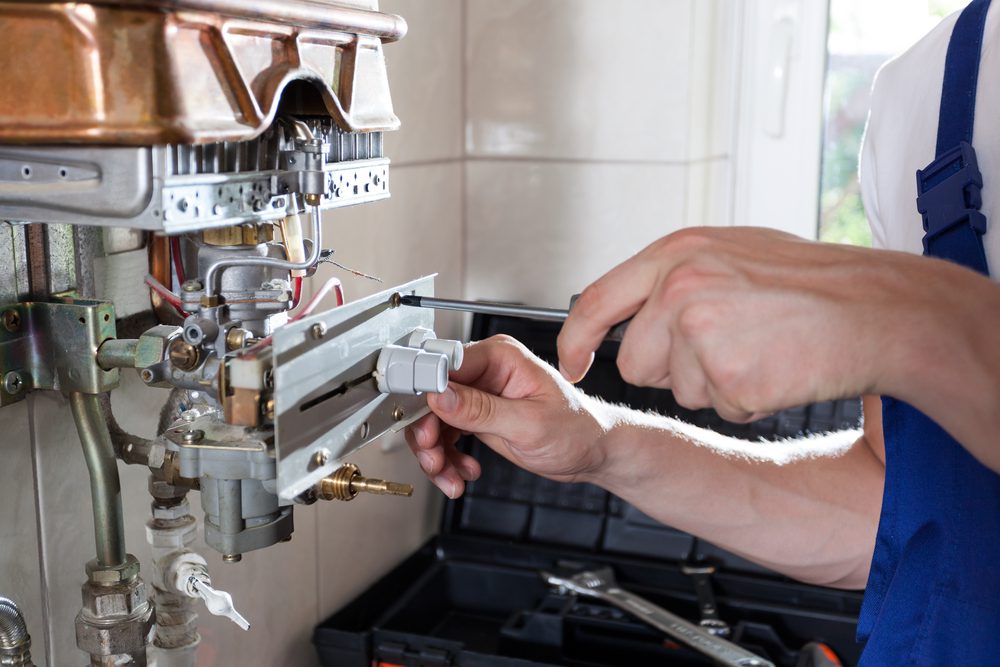 technician working on gas water heater